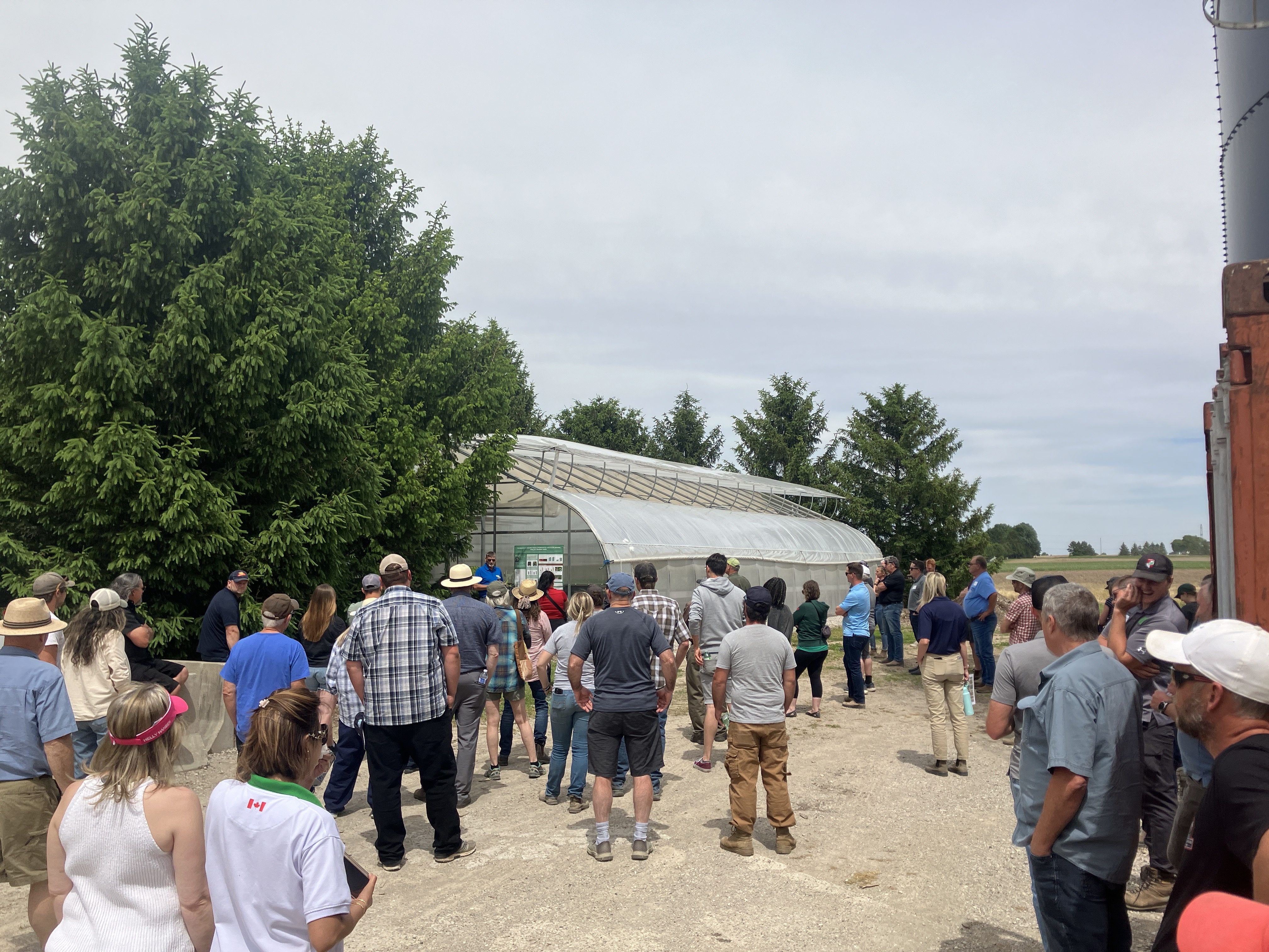 Growers standing outside Garlic Clean Seed Greenhouse